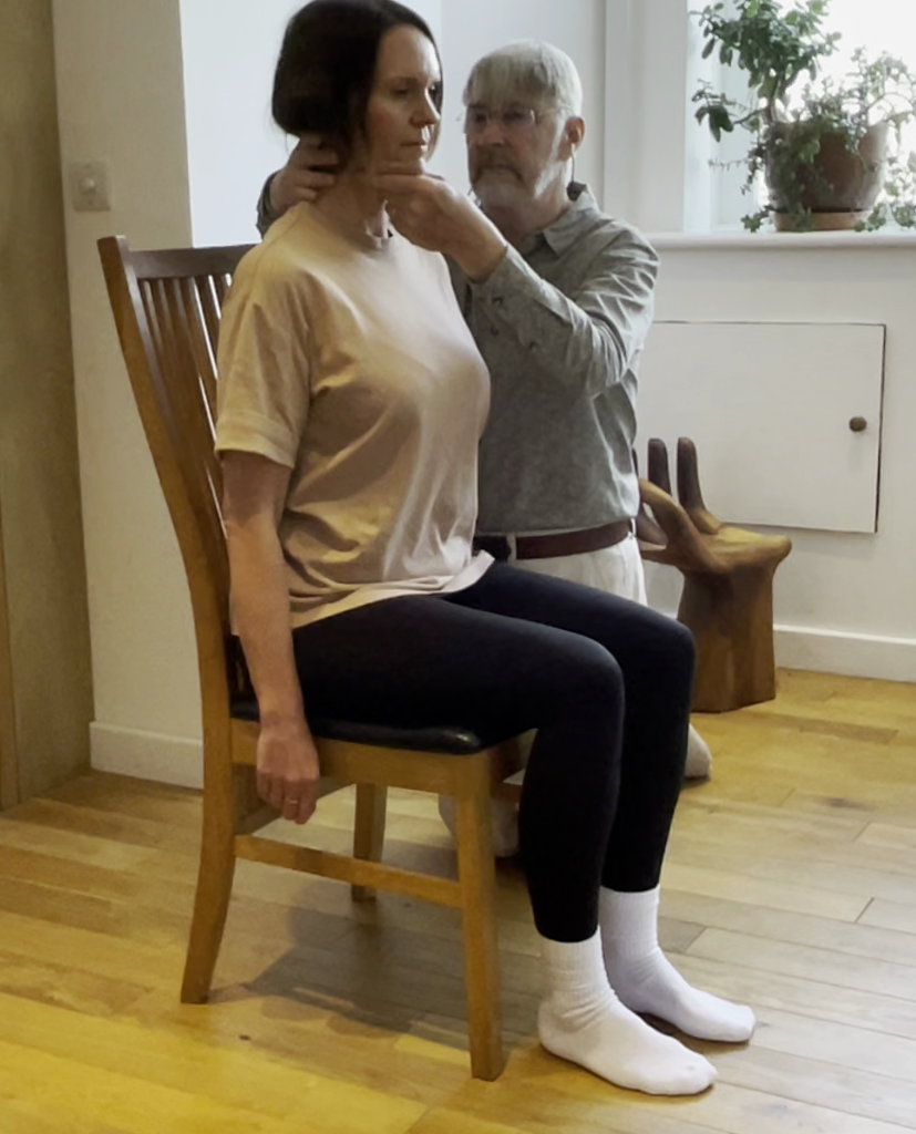 Guiding someone to sit upright, using their natural buoyancy.