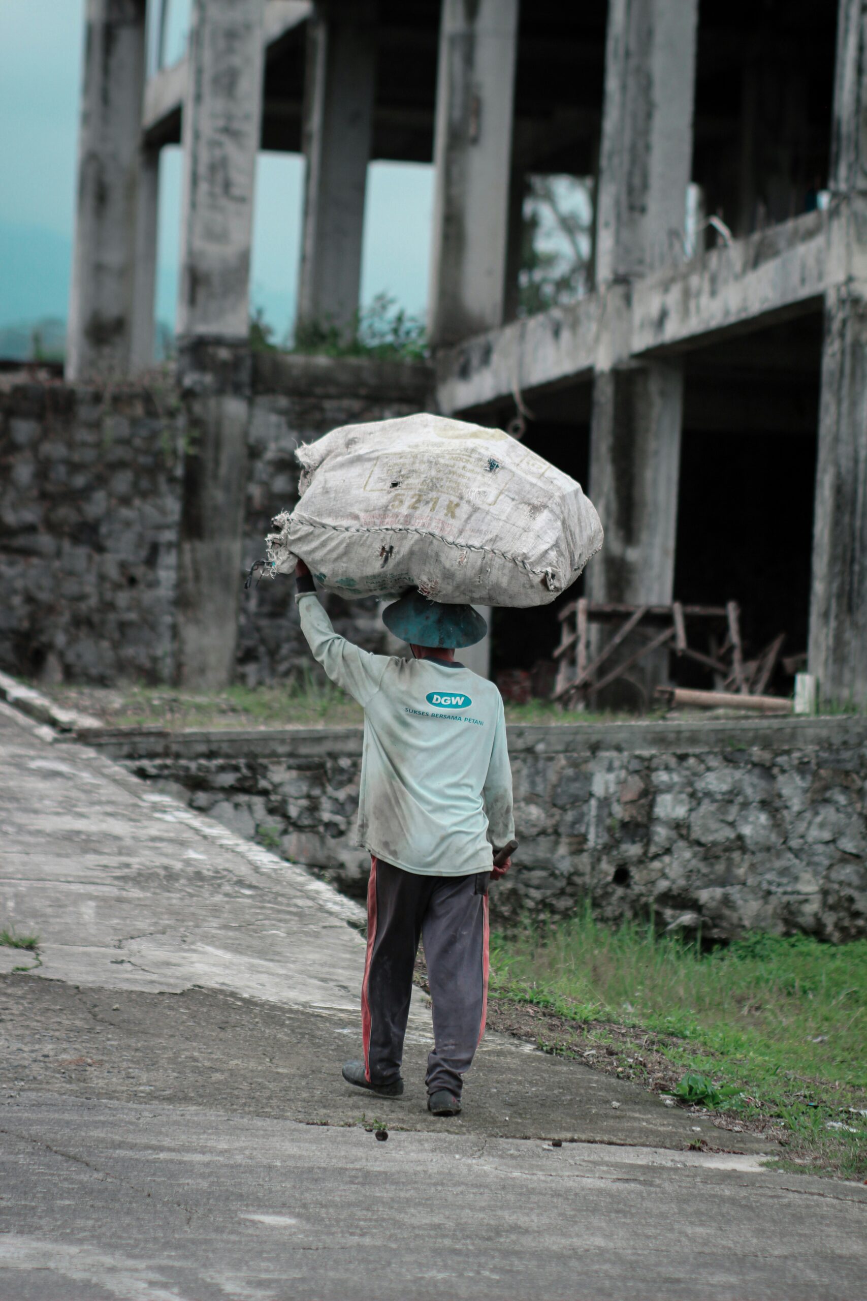A man carrying a large sack on his head.