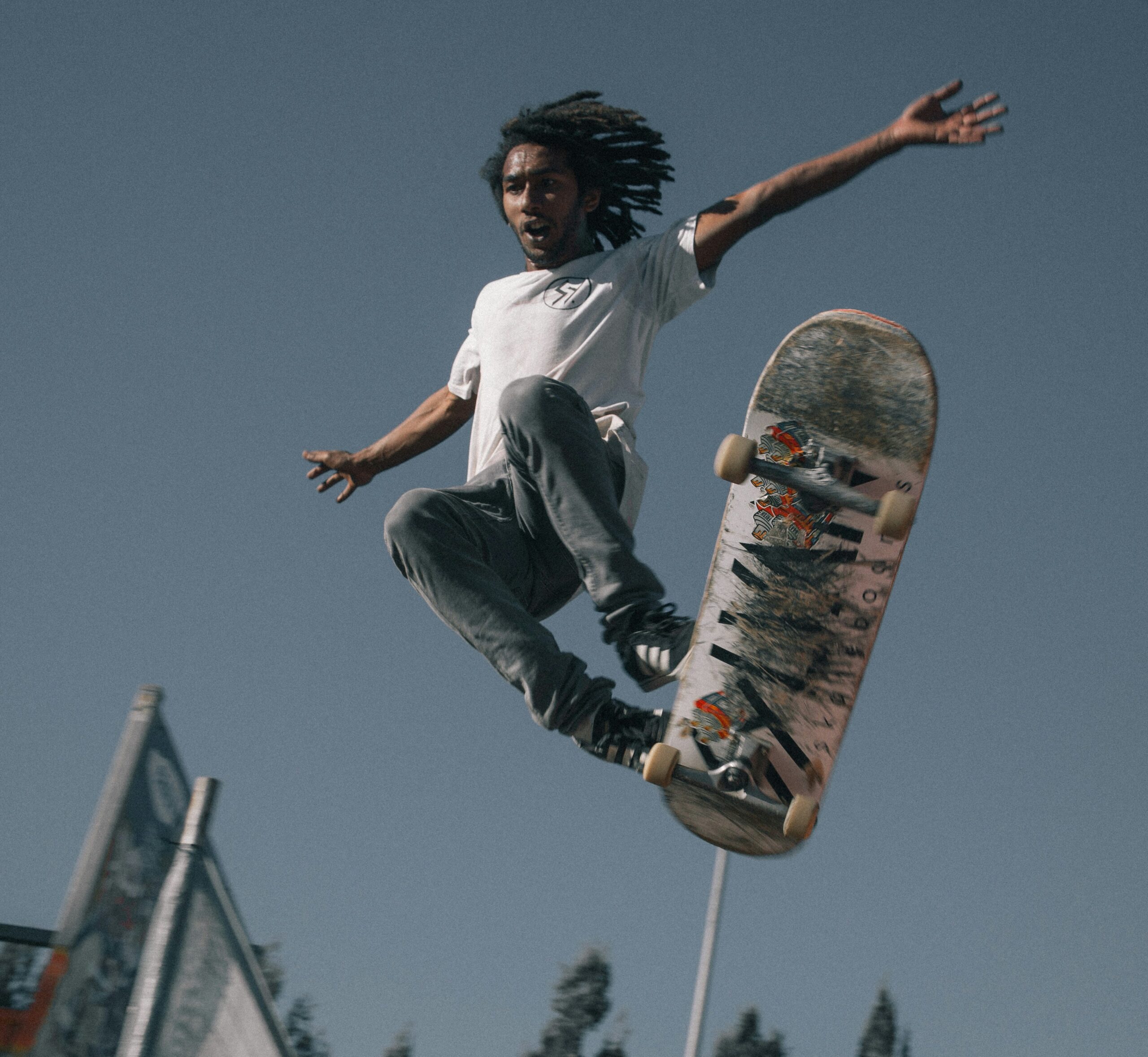 A skateboarder, high in the air.